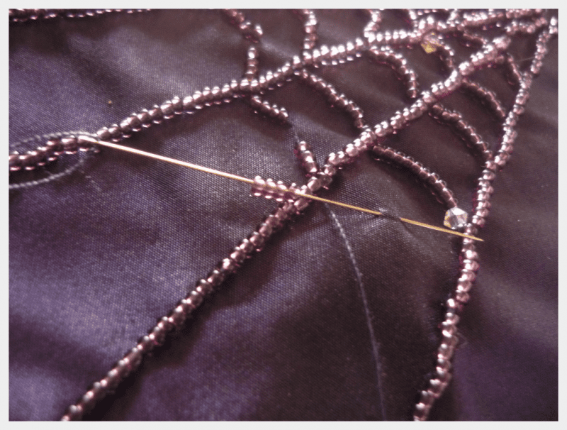 purple hand beaded spiderweb detail