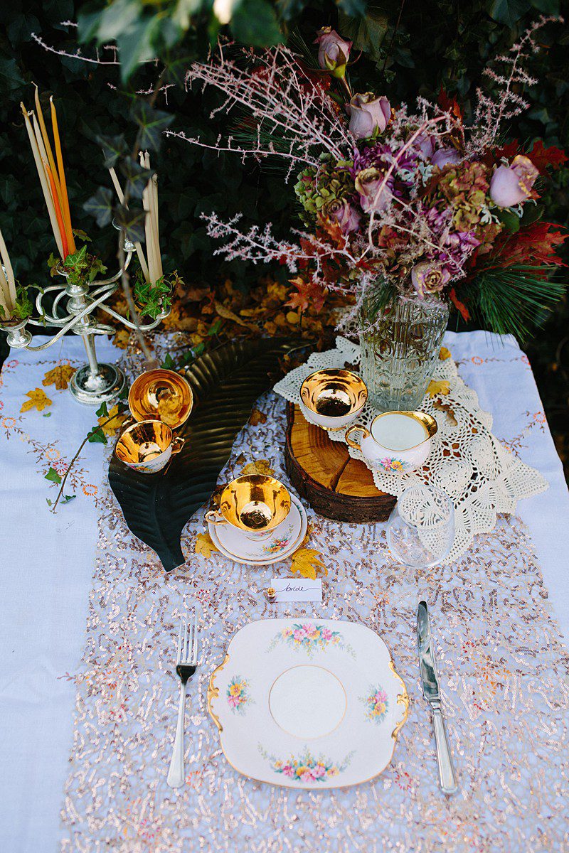 autumn photoshoot table setting inspo gold flowers and candles