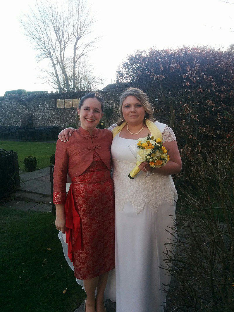 bride with her dressmaker winter wedding lace and chiffon