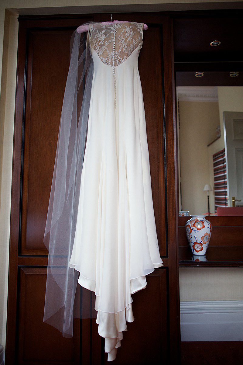 charlie 1 silk satin wedding dress and veil hanging up before the big day