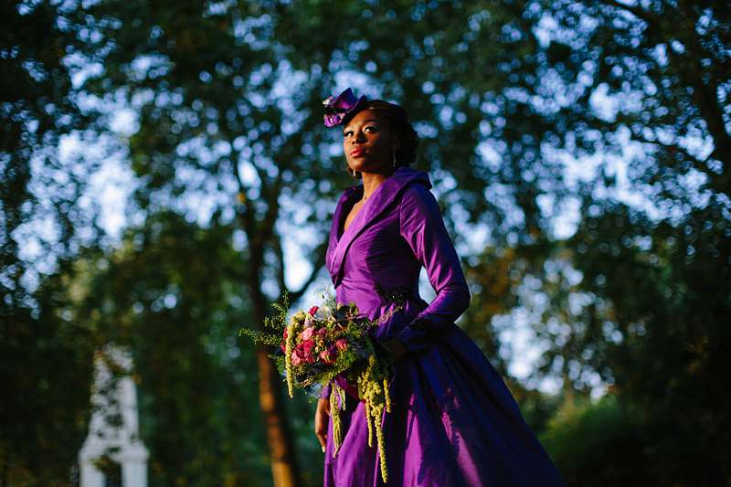 bride against the dress with bouquet