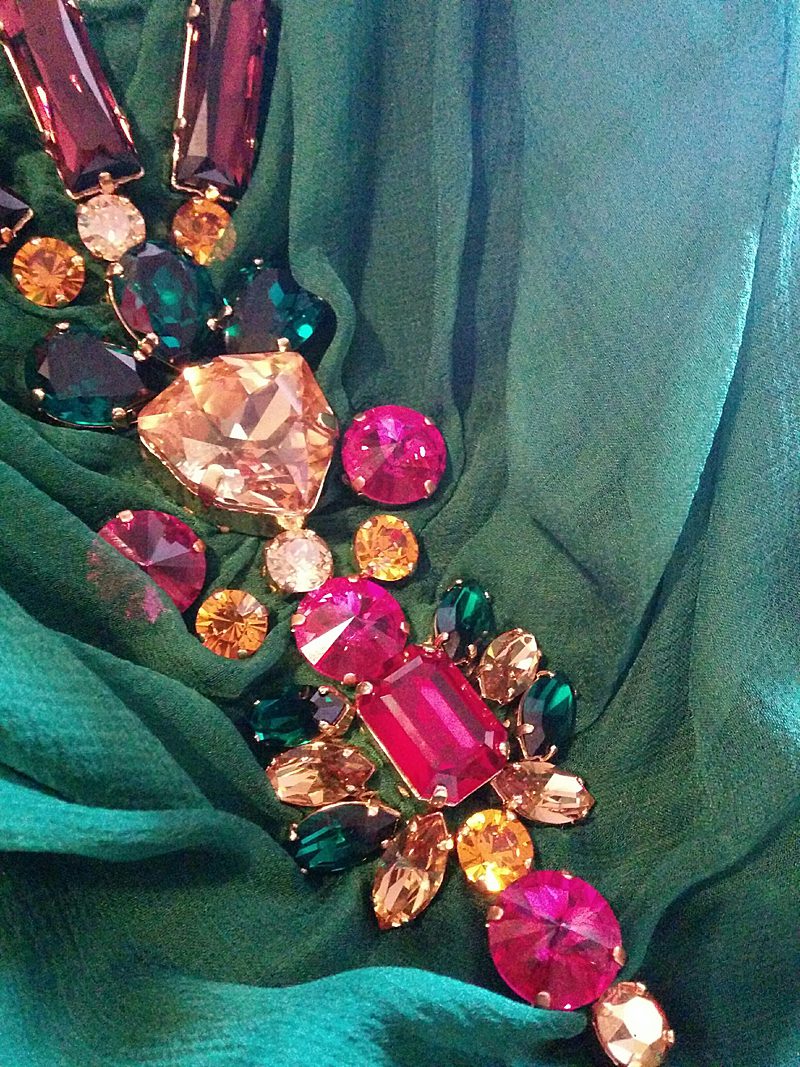 detail of hand embellishment to cowl back dress jewel bright pink yellow green