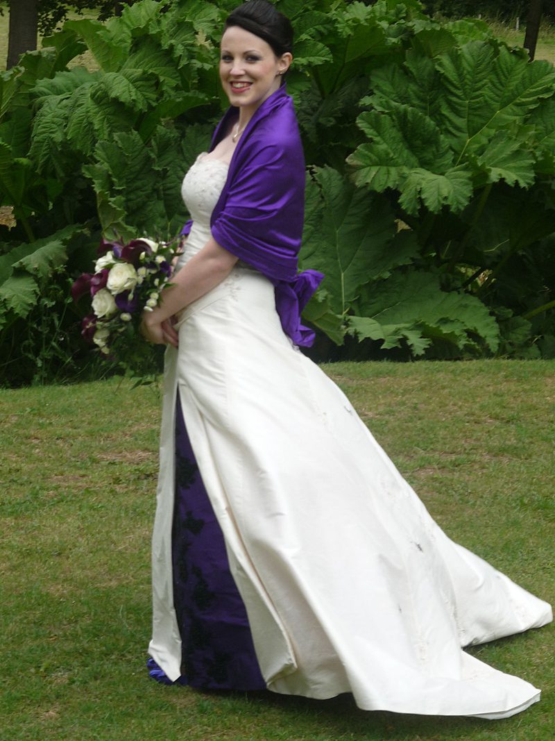 simple modern wedding dress with purple wrap stole