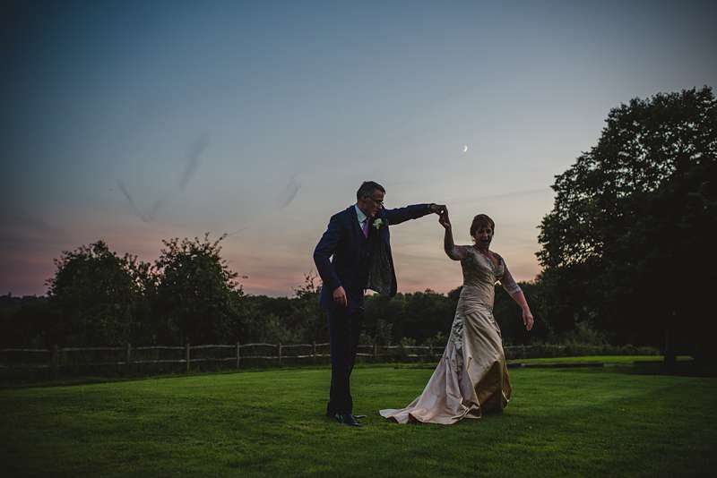 sunset wedding picture with pale gold wedding dress