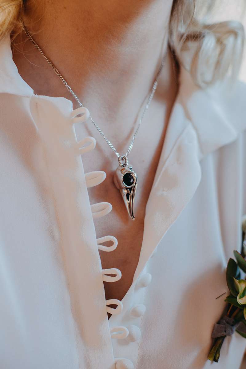 skull necklace pendant silk loop and button blouse