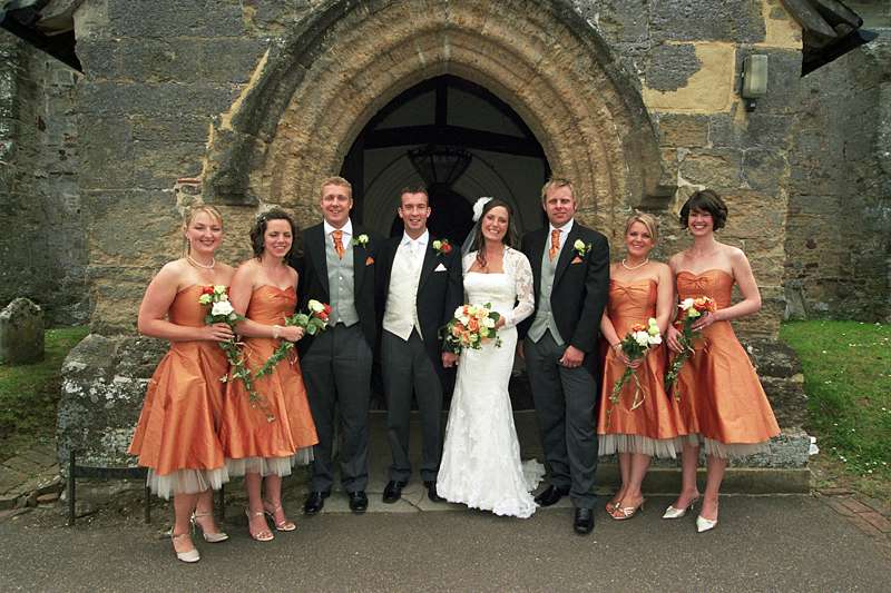 wedding party in orange silk and ivory