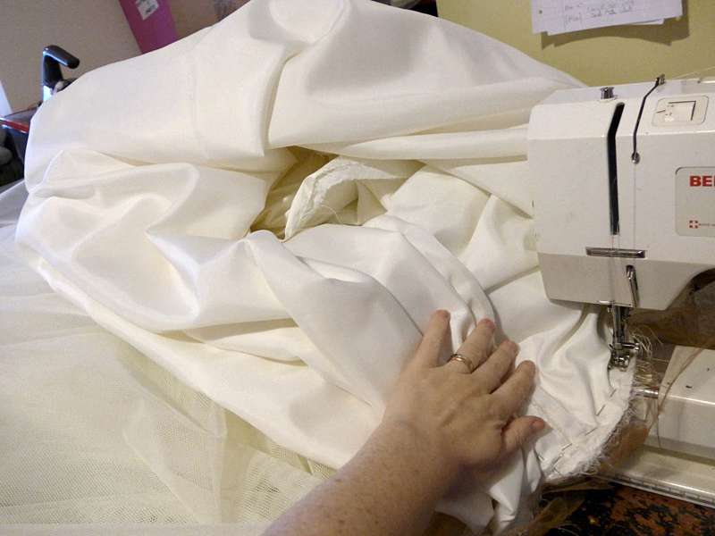 bespoke dressmaker in the studio machine sewing