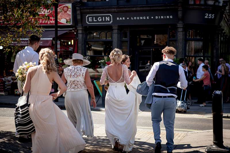 summer town wedding dress lifting the train