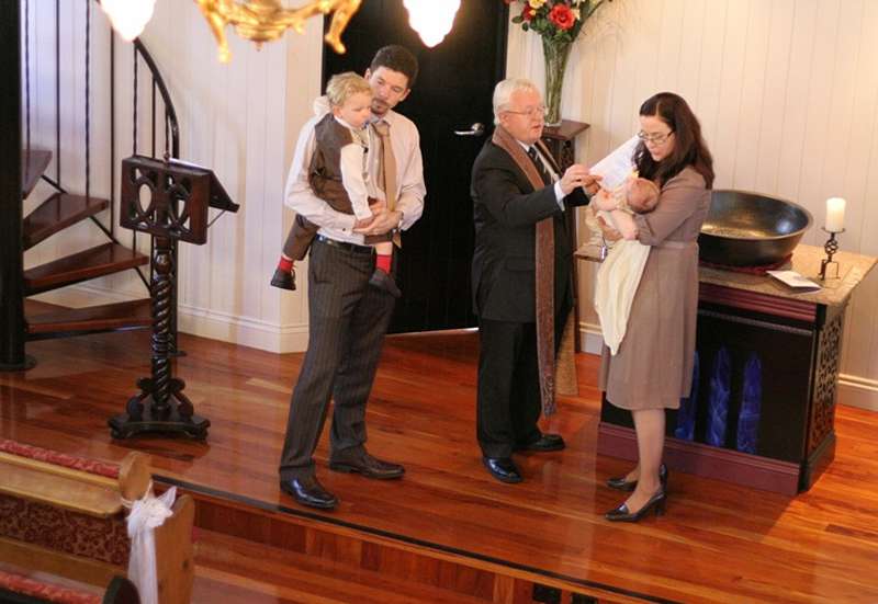 traditional christening gown on babe in arms