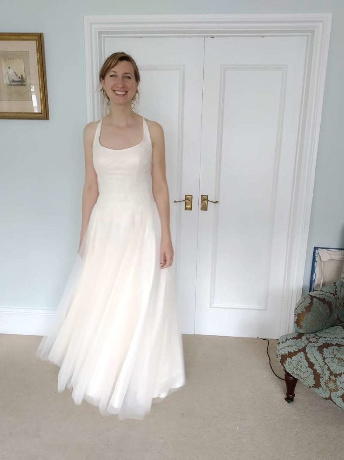 happy bride in circle cut skirt at final fitting couture wedding dress