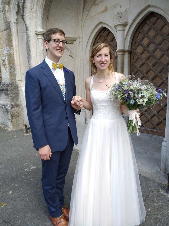 traditional wedding dress bride and bow tie groom outside church wedding