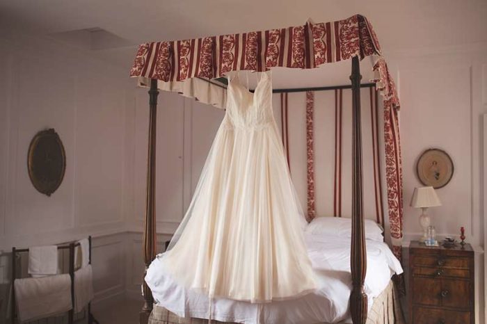 custom wedding dress on four poster bed