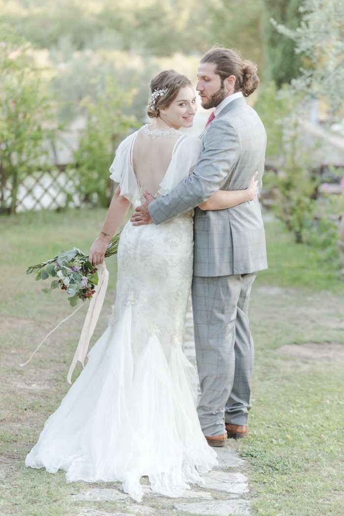 bride glances back in custom made illusion back wedding dress