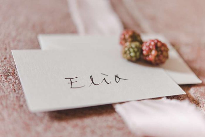 hand written place card with blackberries