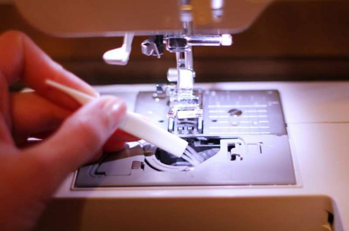 brusing on the bobbin case of your sewing machine