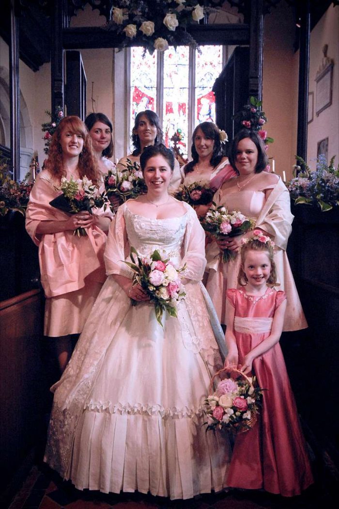 bespoke wedding dress with divided skirt and her bridesmaids