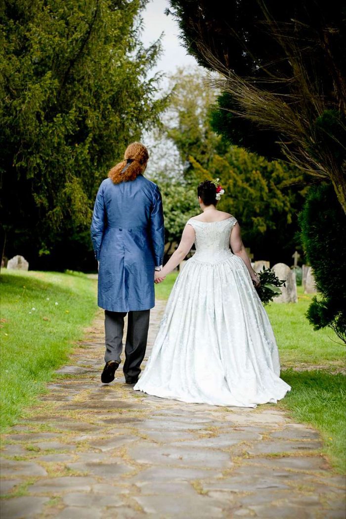 bustle back victorian wedding dress on church path