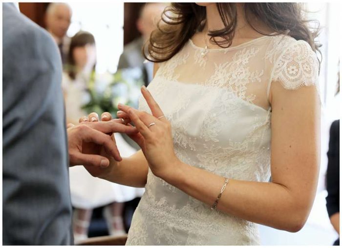 chantilly lace bespoke wedding dress exchanging rings