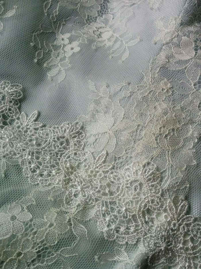 scalloped lace edging detail on blue silk wedding dress