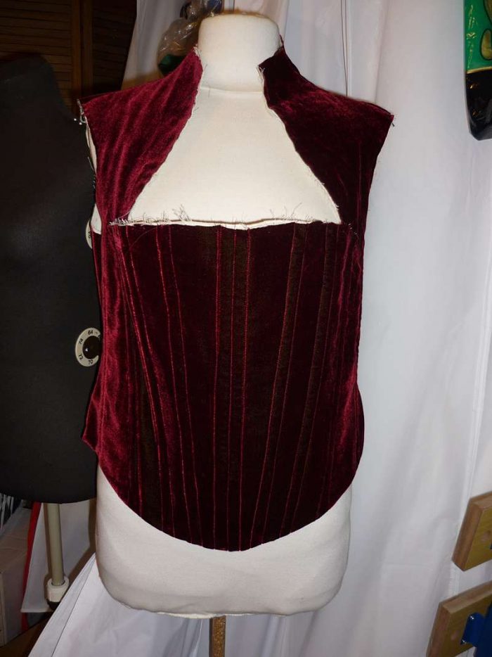 creating the bodice: boning channels in red velvet on the stand