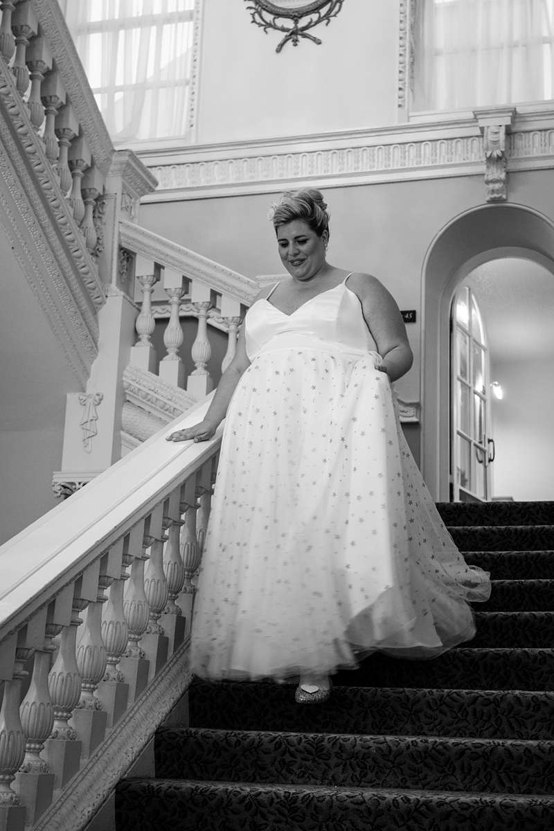 celestial wedding dress for plus size bride on staircase