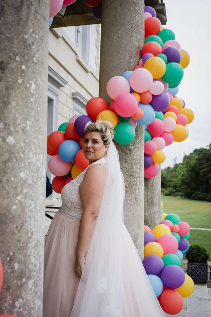 plus size bride in pink wedding dress with veil