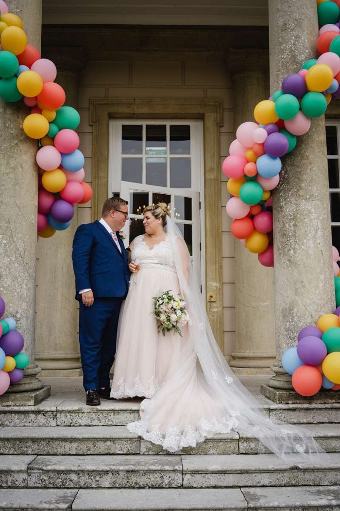 bride with groom, blush wedding dress and balloon decorations