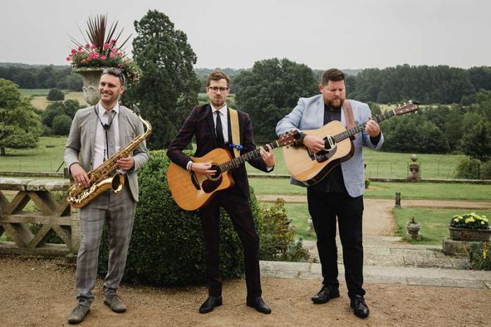 musicians with guitars for a wedding outside