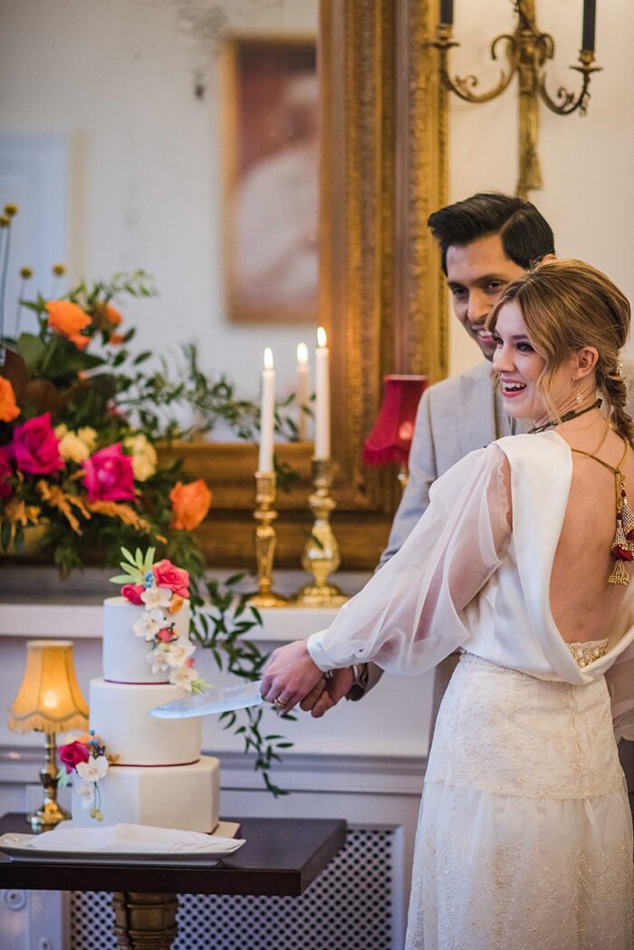 bride and groom cut the cake