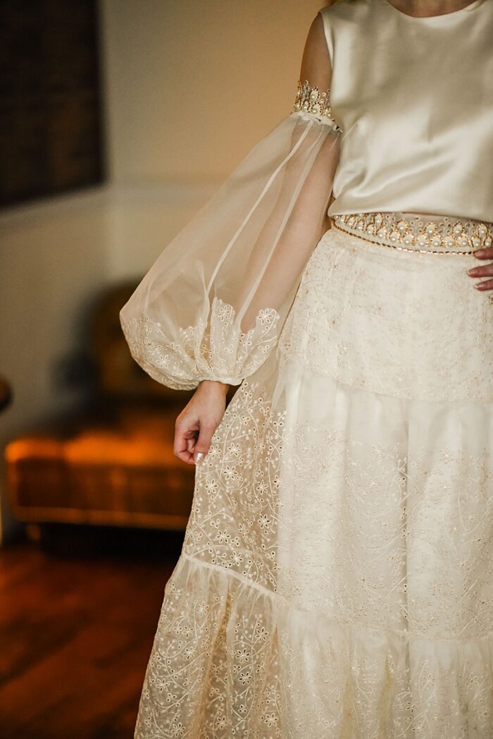 fusion wedding ensemble in ivory and gold organza balloon sleeves and tired skirt