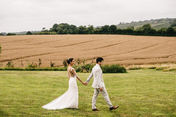 Backless contemporary wedding dress with train and lace detail