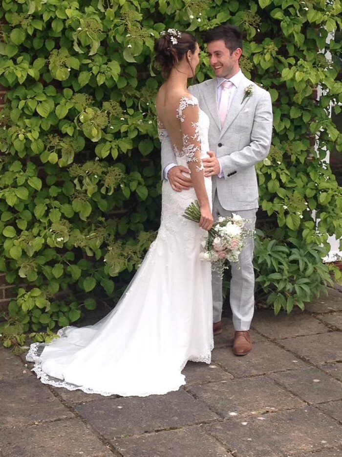 Ivory bespoke wedding dress with scalloped edge train