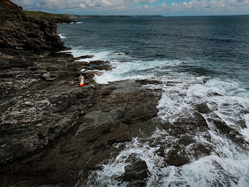 dramatic coastal cliff wedding with custom dip dye wedding dress 