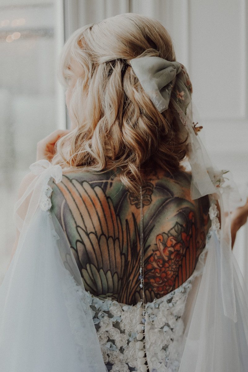 alternative tattoo bride low back button up floral wedding gown shoulder bunny bows wings