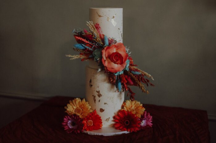 quirky unusual orange floral dried flowers gold detail wedding cake