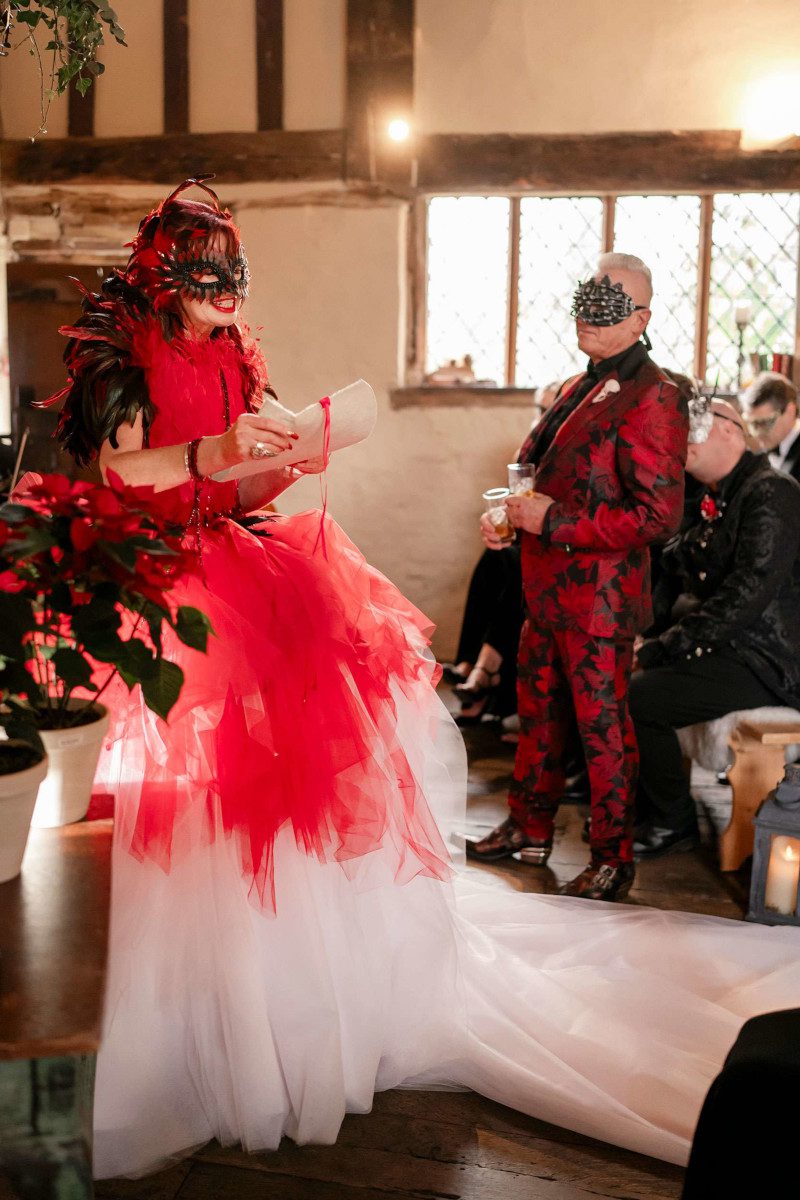 dramatic designer gothic wedding dress ceremony red white black feathers lipstick