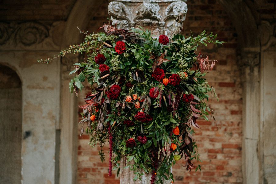 wild dark red bridal flowers outdoor wedding old listed building