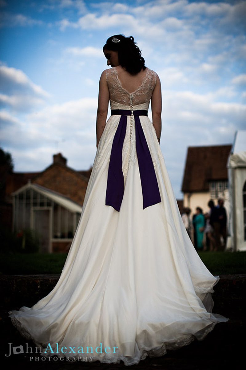 purple sash on custom silk wedding dress