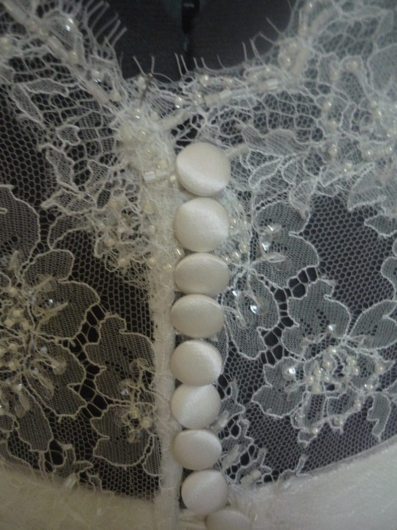 cover buttons and loops on lace back wedding dress