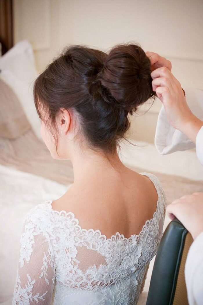 hair style large bun with scallop lace edged and button back wedding dress