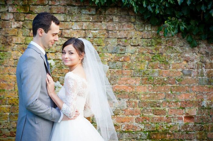 classic bride wearing a corded lace wedding dress bodice and fingertip veil