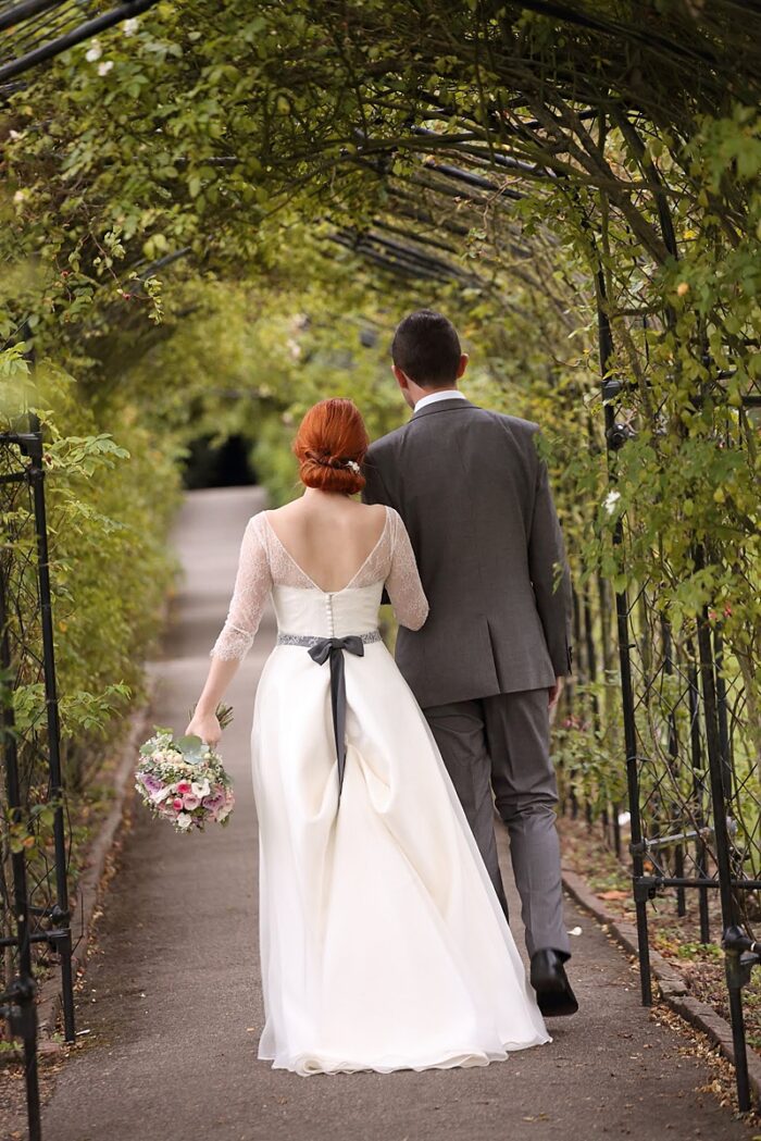 ivory silk organza skirt walking through leafy arches