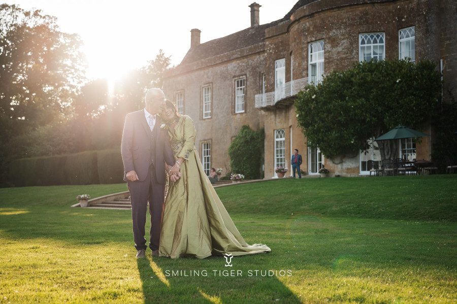 country manor house wedding bride groom three quarter sleeves pleated dress coat light olive sage green