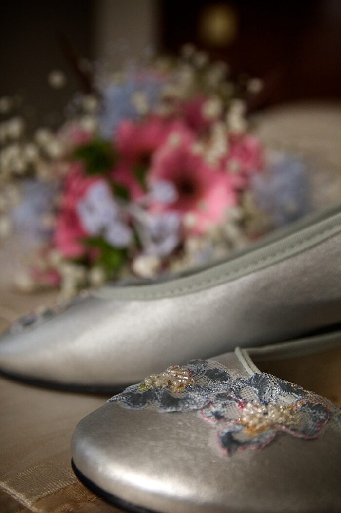 silver wedding shoes with lace flowers