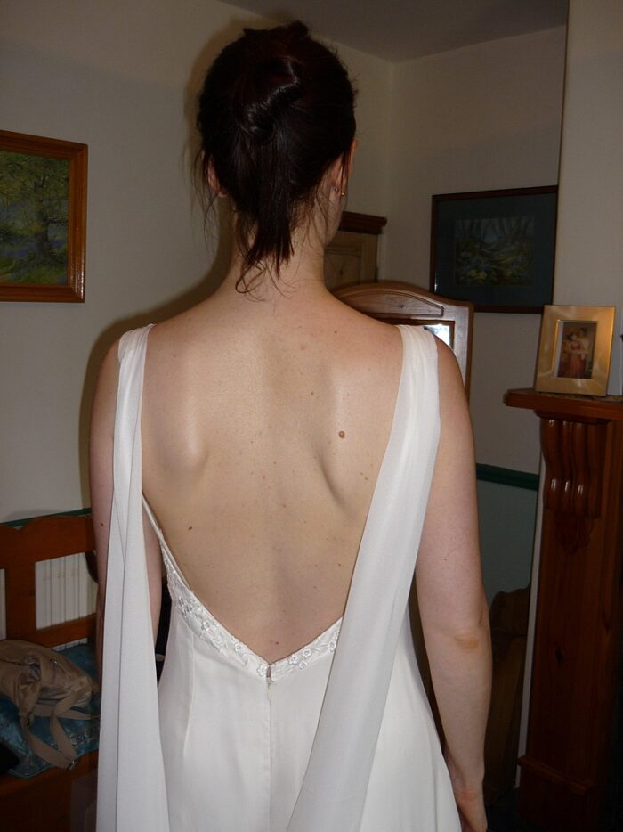 fitting picture low back wedding dress with wing train