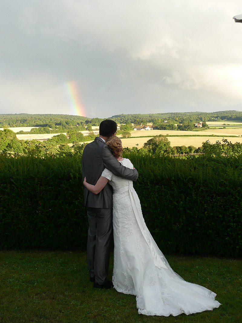 modest wedding dress couple with rainbow