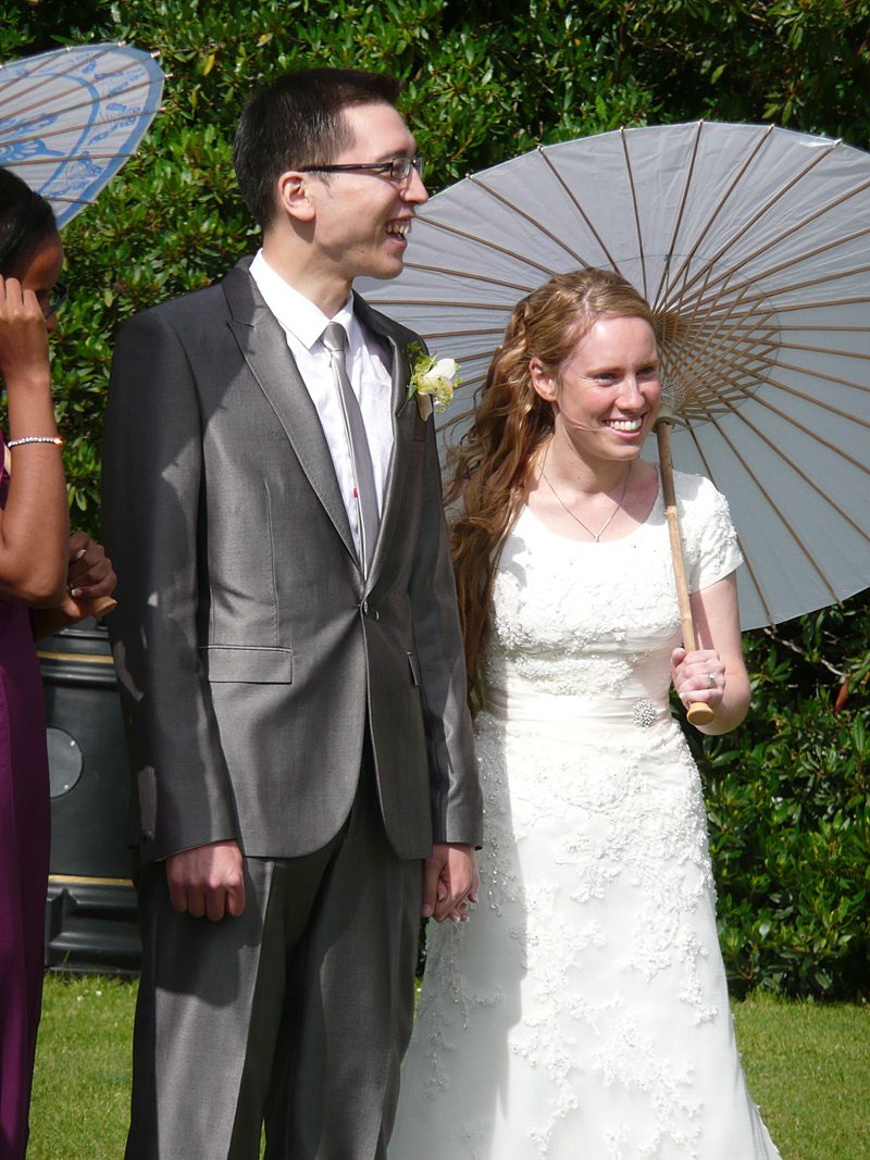 modest lace wedding dress with parasol and sash waist
