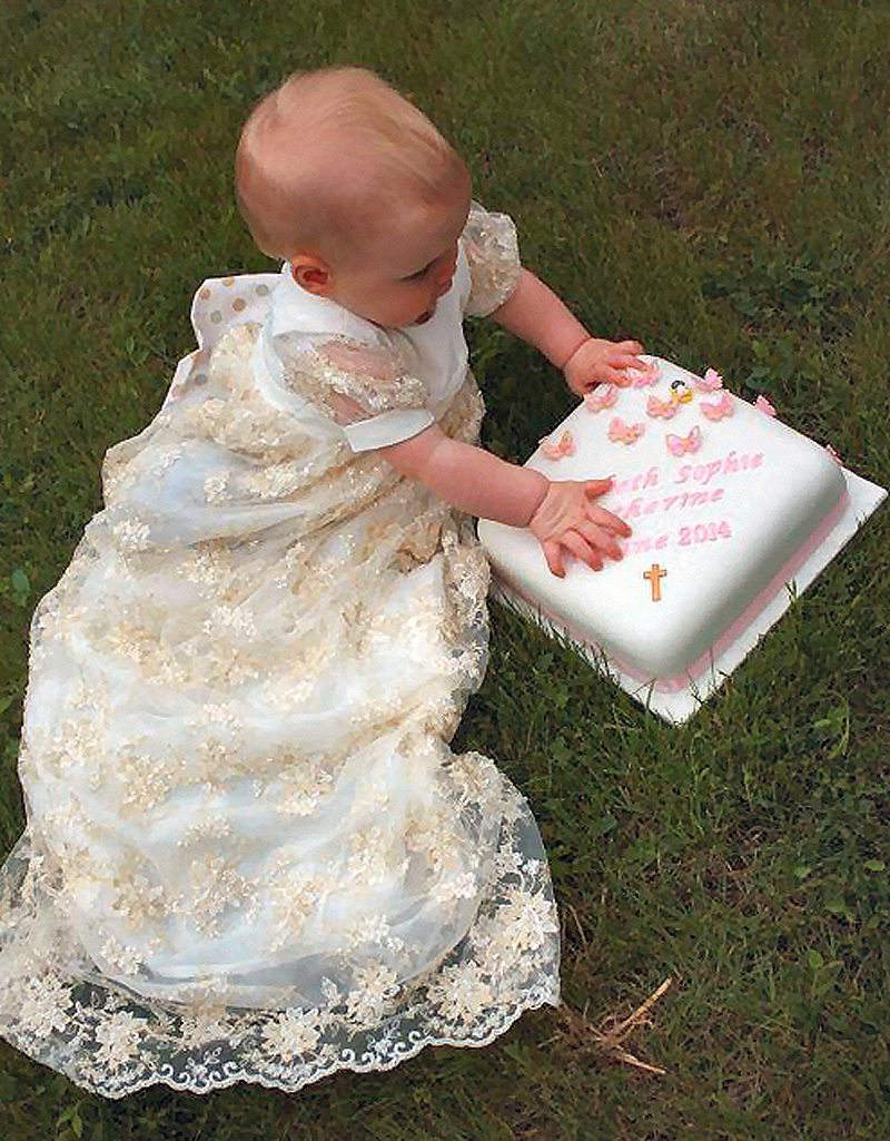 baby in lace bespoke christening gown, long skirt with puff sleeves