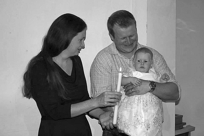 traditional baptism dress held in the ceremony with candle long clothes