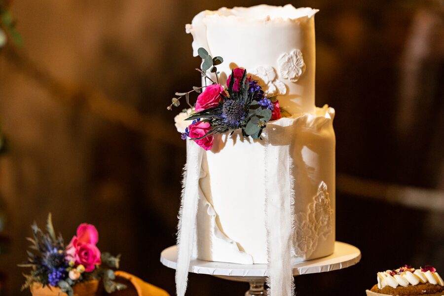 two tiered white floral detail rustic cake frayed chiffon ribbon